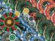 Colorful casino chips surround a roulette wheel, depicting gambling.